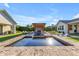 A luxurious pool with a modern water feature and an outdoor kitchen offers relaxation at 3981 E Runaway Bay Pl, Queen Creek, AZ 85142