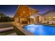 Luxurious pool area featuring a modern cabana with cascading water, outdoor kitchen and lounge seating at 3981 E Runaway Bay Pl, Queen Creek, AZ 85142