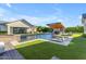A luxurious pool with a modern water feature and an outdoor kitchen for ultimate relaxation at 3981 E Runaway Bay Pl, Queen Creek, AZ 85142