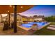 Beautiful outdoor living space with sparkling pool, modern grill area, and comfortable lounge seating at 3981 E Runaway Bay Pl, Queen Creek, AZ 85142