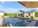 Luxurious pool area with waterfall features, lounge chairs, and well-manicured landscaping at 3981 E Runaway Bay Pl, Queen Creek, AZ 85142