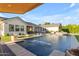 Backyard featuring a modern pool, water features, comfortable lounge chairs, and lush landscaping at 3981 E Runaway Bay Pl, Queen Creek, AZ 85142