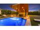 Stunning pool with modern waterfall feature and stylish lounge area for ultimate relaxation at 3981 E Runaway Bay Pl, Queen Creek, AZ 85142
