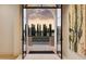 View from foyer through open glass doors, highlighting the home's seamless connection with the outdoors at 6633 E Horseshoe Rd, Paradise Valley, AZ 85253