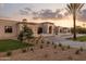 Sweeping view of the property, displaying the well-maintained landscape and attractive architectural design against a colorful sky at 6633 E Horseshoe Rd, Paradise Valley, AZ 85253