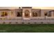 Beautiful home exterior featuring a manicured lawn and a grand arched entryway, exuding elegance and curb appeal at 6633 E Horseshoe Rd, Paradise Valley, AZ 85253