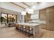 Open-concept kitchen featuring a large marble island, modern appliances, and elegant lighting fixtures at 6633 E Horseshoe Rd, Paradise Valley, AZ 85253