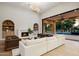 Bright living room with a fireplace and a large sliding glass door leading to the pool and backyard at 6633 E Horseshoe Rd, Paradise Valley, AZ 85253