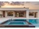 Backyard swimming pool with integrated spa, outdoor kitchen, and open access from the living room at 6633 E Horseshoe Rd, Paradise Valley, AZ 85253