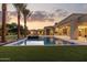 Stunning pool area with lush landscaping, featuring palm trees and impeccable outdoor living spaces at 6633 E Horseshoe Rd, Paradise Valley, AZ 85253