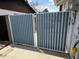 Image of a blue metal gate at the side of the house, providing access to the backyard at 12836 N 39Th Ln, Phoenix, AZ 85029