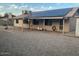 The backyard features a covered patio area, solar panels, and gravel ground cover at 12836 N 39Th Ln, Phoenix, AZ 85029