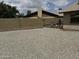 View of gravel-covered backyard space enclosed by a block wall, with neighboring houses visible at 12836 N 39Th Ln, Phoenix, AZ 85029