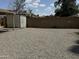 Open backyard with a shed and a gravel-covered area, surrounded by a block fence at 12836 N 39Th Ln, Phoenix, AZ 85029