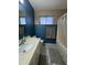 Full bathroom with a sink, toilet, bathtub, and window with natural light at 12836 N 39Th Ln, Phoenix, AZ 85029