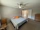 Neutral bedroom with ceiling fan, bedside table, dressers and view into hallway and ensuite at 12836 N 39Th Ln, Phoenix, AZ 85029