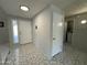 View of the home's entryway with neutral walls, a door, and ceramic tiling at 12836 N 39Th Ln, Phoenix, AZ 85029