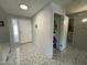 View of the home's entryway with neutral walls, a door, and ceramic tiling and showing the pantry at 12836 N 39Th Ln, Phoenix, AZ 85029