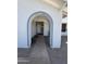 Covered front entrance with a brick trimmed archway at 12836 N 39Th Ln, Phoenix, AZ 85029