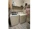 A conveniently located laundry area featuring a washer, dryer, and overhead storage shelves at 12836 N 39Th Ln, Phoenix, AZ 85029