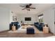 Inviting living room with a ceiling fan, blue sofas, and a bright, airy feel at 2022 N 124Th Dr, Avondale, AZ 85392