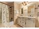 Elegant bathroom featuring double sinks, vanity, and tiled shower at 21483 N 65Th Ave, Glendale, AZ 85308