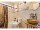 Bathroom featuring decorative tile-work, decorative sink and faucets, with neutral paint and fixtures at 21483 N 65Th Ave, Glendale, AZ 85308