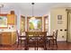 Eat-in kitchen and dining area featuring a bay window with views of the backyard and mature trees at 21483 N 65Th Ave, Glendale, AZ 85308
