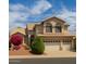 Charming two-story home with a three-car garage and well-maintained landscaping at 21483 N 65Th Ave, Glendale, AZ 85308