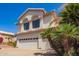 Attractive two-story home with a three-car garage and desert landscaping with palms at 21483 N 65Th Ave, Glendale, AZ 85308
