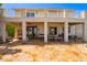 Rear view of the house with a covered patio and balcony overlooking the backyard at 21483 N 65Th Ave, Glendale, AZ 85308