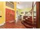 Spacious foyer featuring wood floors, a staircase, chandelier, and large front doors at 21483 N 65Th Ave, Glendale, AZ 85308
