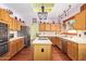 Spacious kitchen features a center island with cooktop, stainless steel appliances, and bright lighting at 21483 N 65Th Ave, Glendale, AZ 85308