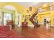 Spacious open-concept living room featuring wood floors, staircase, and dining area at 21483 N 65Th Ave, Glendale, AZ 85308