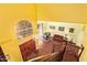 Bright, colorful living room showcasing high ceilings, a grand piano, and staircase from an elevated viewpoint at 21483 N 65Th Ave, Glendale, AZ 85308