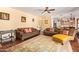Spacious living room with hardwood floors, comfortable seating, and a seamless transition into the kitchen at 21483 N 65Th Ave, Glendale, AZ 85308