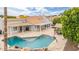 An aerial view of the backyard, featuring a pool, patio, pergola, and well-maintained lawn at 2431 E Laurel St, Mesa, AZ 85213