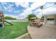 Lush backyard featuring a play structure, outdoor dining area, and mature trees, creating a perfect outdoor retreat at 2431 E Laurel St, Mesa, AZ 85213