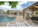 A spacious backyard patio with a pergola, seating, and a pool, perfect for outdoor entertaining at 2431 E Laurel St, Mesa, AZ 85213