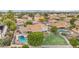 Aerial view of a backyard featuring a sparkling pool, lush greenery, and a play area at 2431 E Laurel St, Mesa, AZ 85213