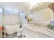 Bright bathroom with a soaking tub, marble countertops, and a modern farmhouse sink for a fresh and luxurious feel at 2431 E Laurel St, Mesa, AZ 85213
