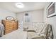Cozy bedroom featuring neutral paint, soft lighting, a chair, and storage at 2431 E Laurel St, Mesa, AZ 85213