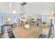 Dining room with a long wooden table, upholstered chairs, and stylish pendant lighting at 2431 E Laurel St, Mesa, AZ 85213