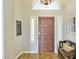 Welcoming entryway featuring a dark wooden door, light grey walls, and elegant decorative touches at 2431 E Laurel St, Mesa, AZ 85213