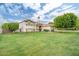 Spacious home with well-maintained lawn, stone accents, red tile roof and mature trees at 2431 E Laurel St, Mesa, AZ 85213