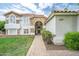 Inviting front entrance with a brick walkway leading to an arched doorway and meticulously manicured landscaping at 2431 E Laurel St, Mesa, AZ 85213
