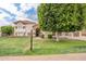 Attractive home with stone detailing, a red tile roof, and a well-manicured lawn and a 'For Sale' sign at 2431 E Laurel St, Mesa, AZ 85213
