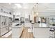 Modern kitchen featuring white cabinets, granite countertops, stainless steel appliances, and a large island at 2431 E Laurel St, Mesa, AZ 85213