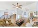 Open living room with beautiful floors, ceiling fans, neutral paint and a dining area beyond at 2431 E Laurel St, Mesa, AZ 85213