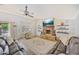 Cozy living room featuring a stone fireplace, ceiling fan, and comfortable seating area at 2431 E Laurel St, Mesa, AZ 85213
